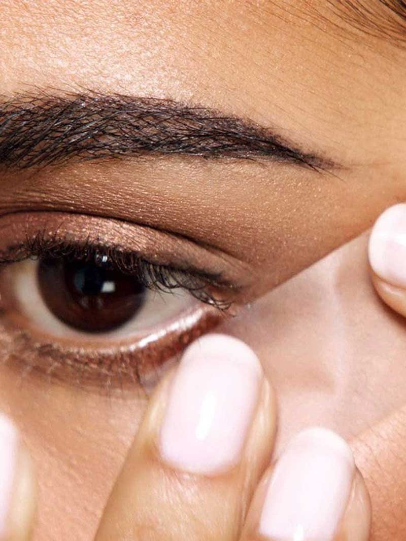 Woman using tape under her eye